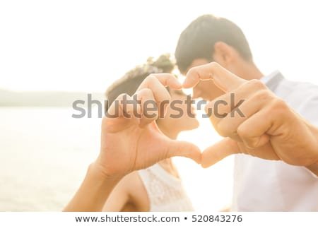 couple-love-gesturing-heart-fingers-450w-520843276.jpg