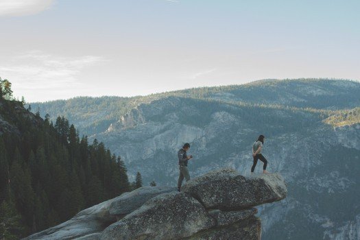 tourists-standing-on-rocks-in-mountains.jpg