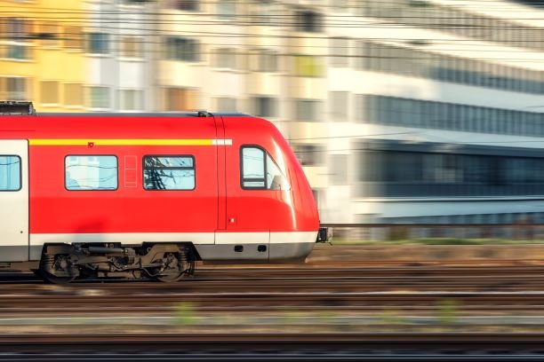 high-speed-red-train-in-motion-at-sunset-PNJ4WG3.jpg