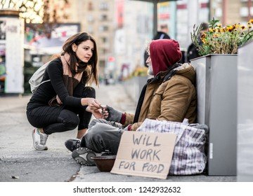 young-woman-giving-money-homeless-260nw-1242932632.jpg