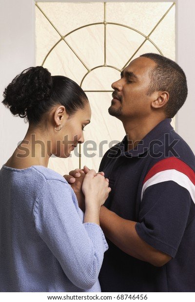 couple-praying-together-600w-68746456.jpg