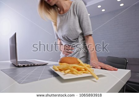 stock-photo-woman-having-stomachache-because-of-eating-unthelthy-junk-food-chronic-gastritis-or-ulcer-1065893918.jpg