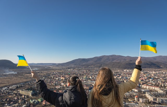 women-with-flags-ukraine-against-background-sky-mountains.jpg