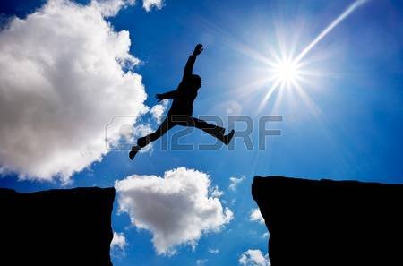 41751213-man-jumping-across-the-gap-from-one-rock-to-cling-to-the-other-man-jumping-over-rocks-with-gap-on-su.jpg