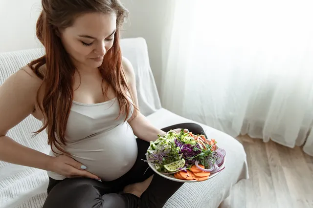 expectant-mother-last-months-pregnancy-is-holding-plate-vegetable-salad_169016-10999.webp