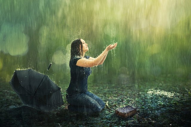 a-woman-enjoys-a-rain-shower-in-the-forest_HiNealZcIvx.jpg