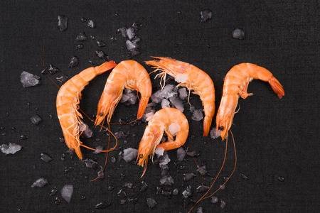 61107155-fresh-orange-shrimp-on-ice-on-black-table-top-view-culinary-seafood-eating-.jpg