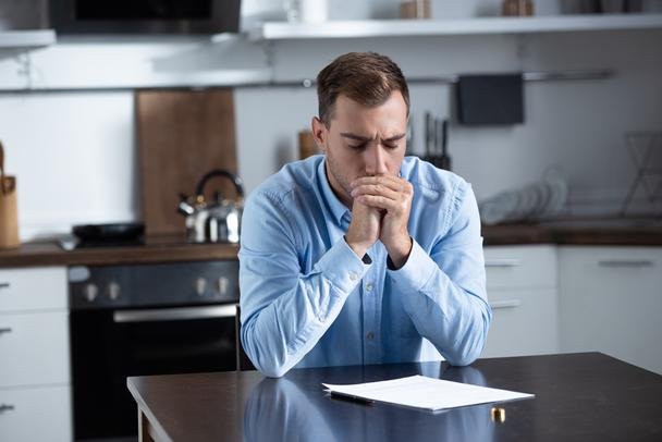 stock-photo-sad-man-shirt-sitting-table.jfif