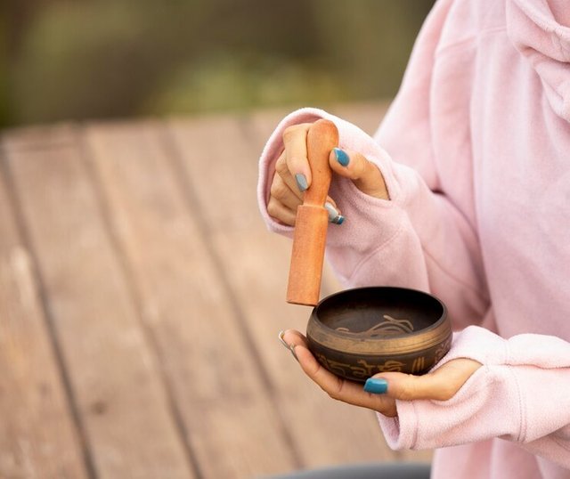 woman-outdoors-holding-singing-bowl-with-copy-space_23-2148769575.jpg