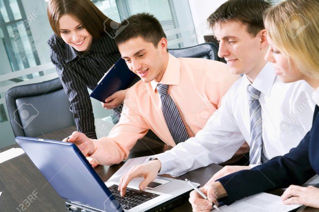 12150844-happy-business-people-working-at-the-office.jpg