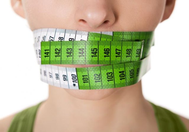 woman-with-tape-measure-around-mouth.jpg