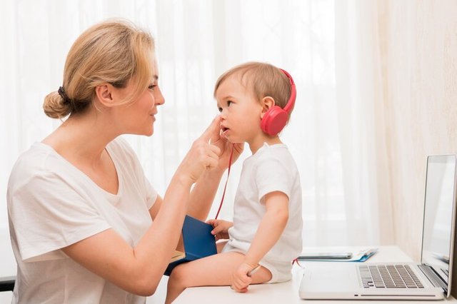 mid-shot-baby-desk-with-headphones-mother-smiling_23-2148552477.jpg