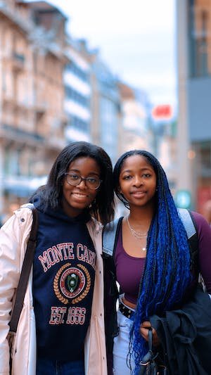 free-photo-of-two-girls-standing-on-the-street-in-city-and-smiling.jpeg