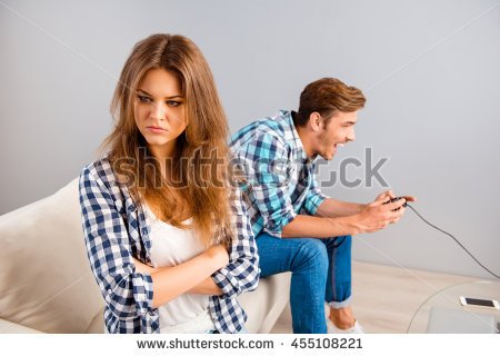 stock-photo-portrait-of-angry-woman-with-crossed-hands-while-her-boyfriend-playing-video-games-455108221.jpg