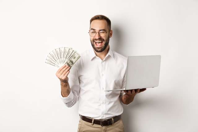 business-e-commerce-confident-businessman-showing-how-work-online-winking-holding-money-laptop-standing.jpg