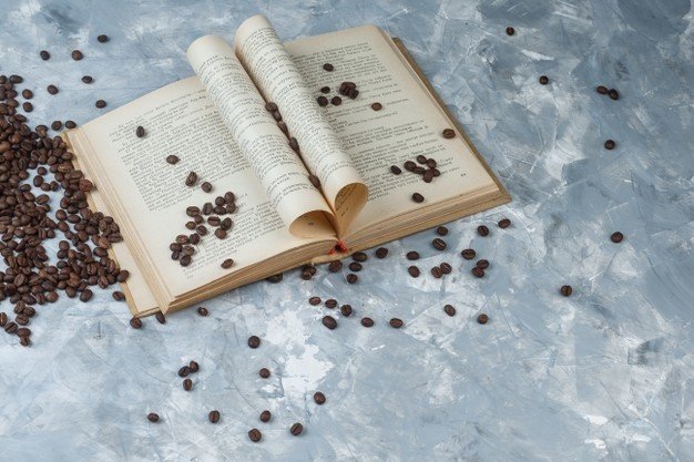 some-coffee-beans-with-book-light-blue-marble-background-high-angle-view_176474-64373.jpg