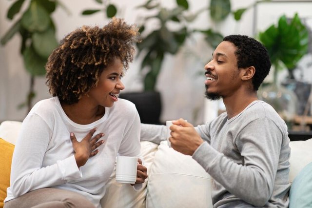 cheerful-loving-black-spouses-drinking-coffee-home_116547-68330.jpg