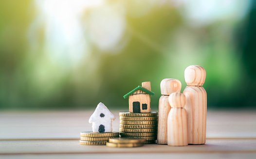 house-placed-on-coins-with-happy-wooden-doll-family-placed-on-the-table-planning-savings.jpg