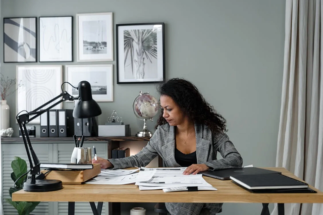 Woman in home-office looking at documents