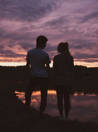 146918967-silhouettes-of-two-teenagers-a-boy-and-a-girl-against-the-background-of-a-bright-purple-sunset-.jpg