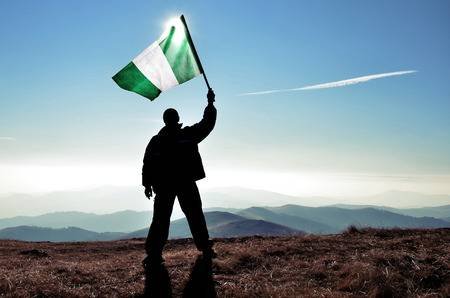 41934303-successful-silhouette-man-winner-waving-nigeria-flag-on-top-of-the-mountain-peak.jpg