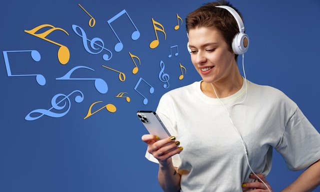 happy-young-woman-listening-music-via-headphones-against-blue-background_93675-149675.jpg