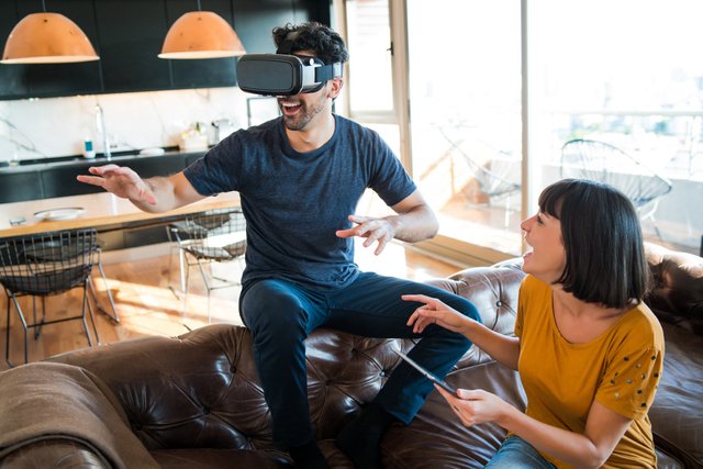 portrait-young-couple-having-fun-together-playing-video-games-with-vr-glasses-while-staying-home.jpg