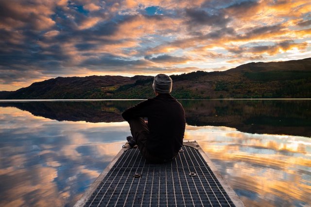 man-sitting-by-lake-1100x733.jpg