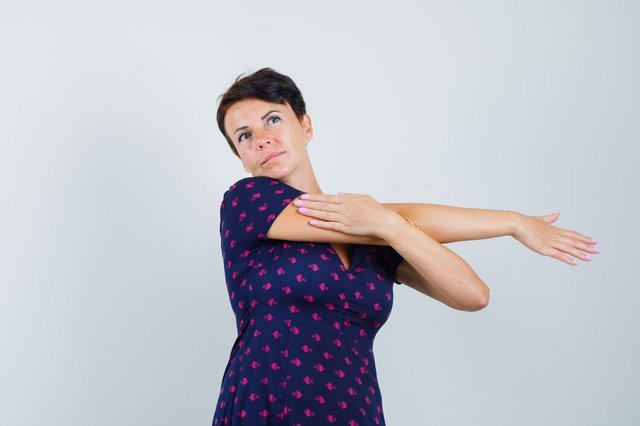 woman-stretching-arms-dress-looking-relaxed_176474-33153.jpg