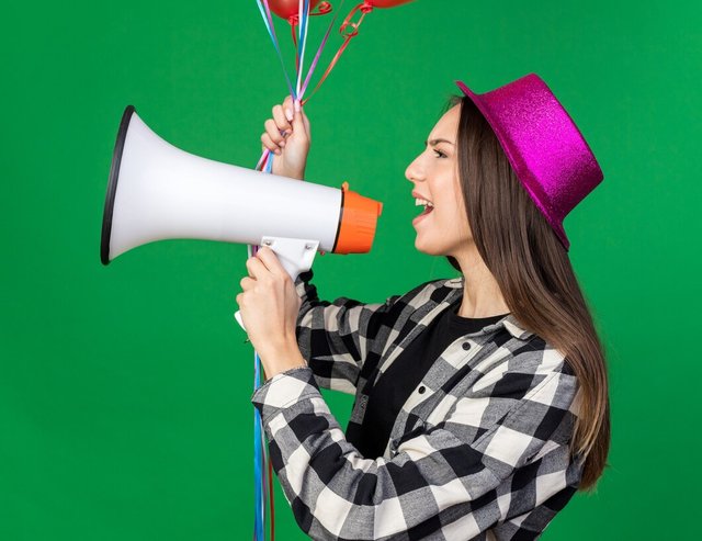 standing-profile-view-young-beautiful-girl-wearing-party-hat-holding-balloons-speaks-loudspeaker_141793-127379.jpg