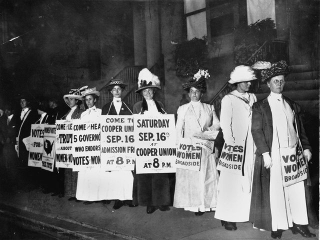 a-line-of-women-rally-for-womens-suffrage-and-advertise-a-free-rally-discussing-womens-right-to-vote-in-washington-dc-on-october-3-1915.jpg