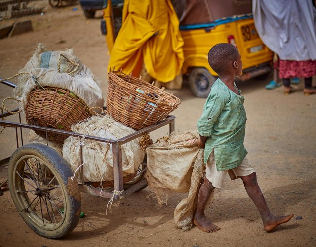 free-photo-of-young-boy-pulling-cart-in-bustling-street-scene.jpeg