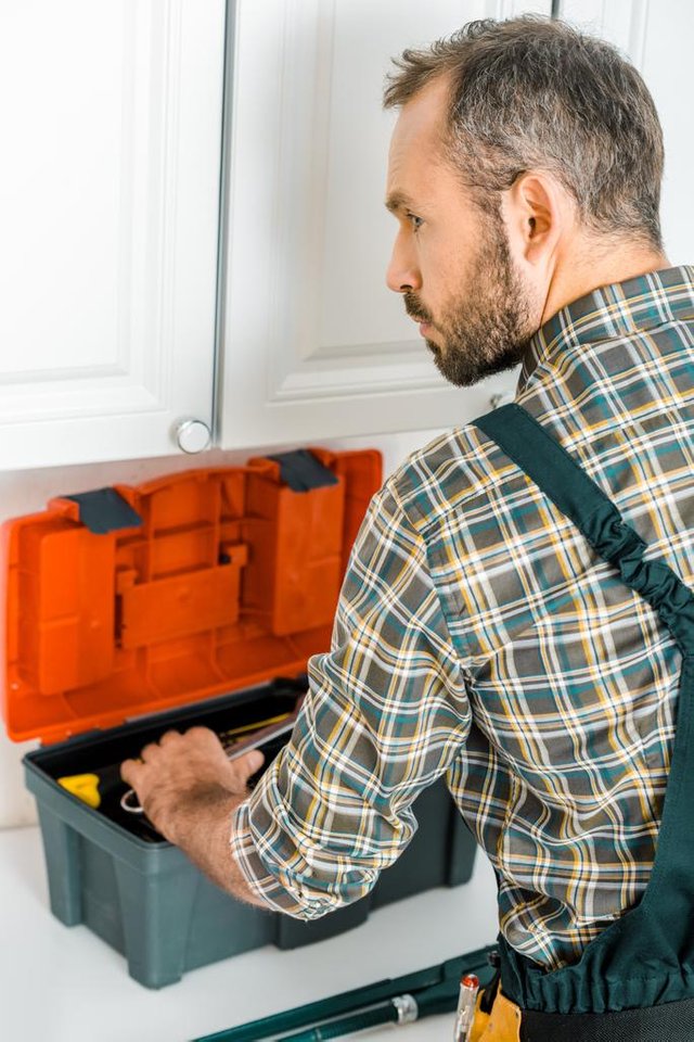 stock-photo-side-view-handsome-plumber-taking.jpg