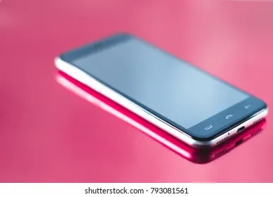 smartphone-on-glossy-pink-background-260nw-793081561.webp