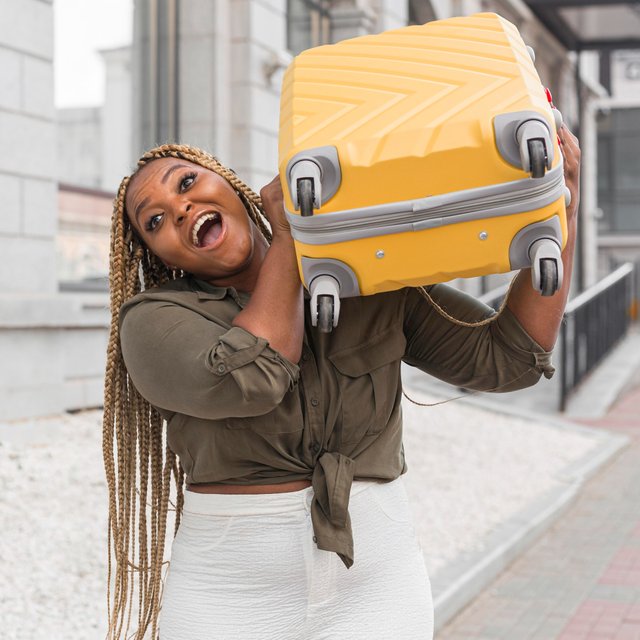 shocked-woman-trying-lift-heavy-luggage-her-shoulder.jpg