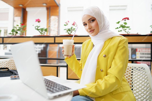 beautiful-young-muslim-woman-using-laptop-while-sitting-cafe_93675-112067.jpg