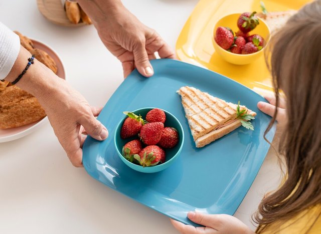 close-up-hands-holding-tray_23-2148971802.jpg