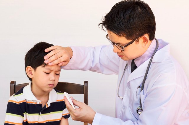 sick-asian-boy-being-examined-by-male-doctor-white-background_1150-6245.jpg