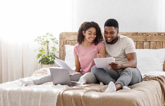 young-black-couple-sitting-bed-home-checking-budget-planning-family-happy-financial-reports-empty-space-184365670.jpg