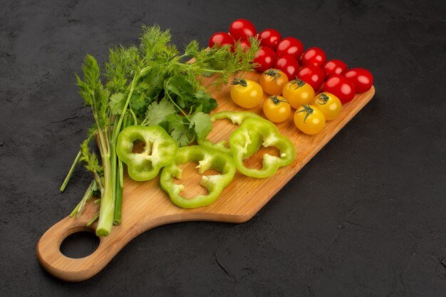 top-view-tomatoes-yellow-red-along-with-sliced-green-bell-pepper-green-leafs-dark-floor_140725-13763.jpg