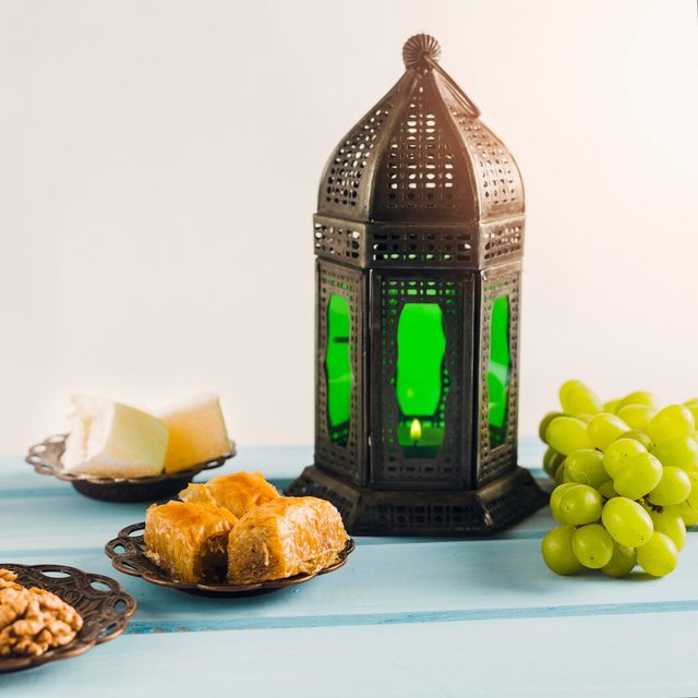 lantern-near-green-grape-with-baklava-turkish-delights-saucers_23-2148111667.jpg