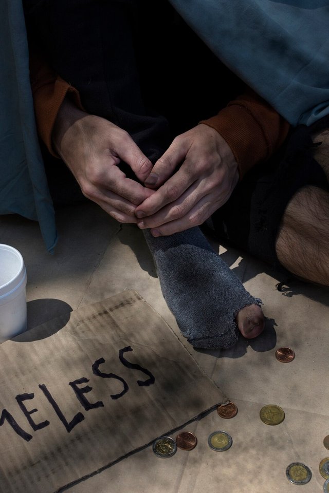 high-view-beggar-person-with-coins-holes-socks_23-2148464309.jpg