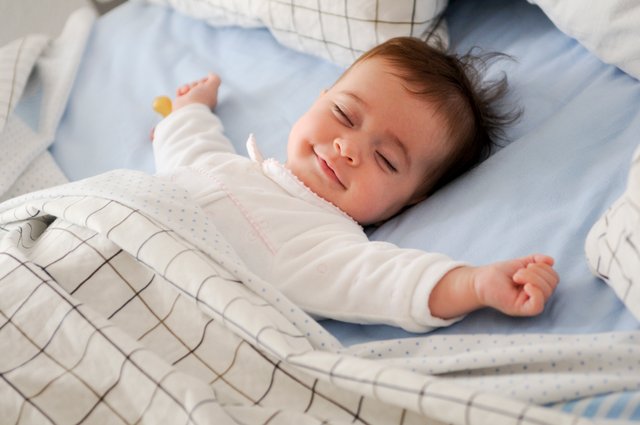 smiling-baby-lying-bed.jpg