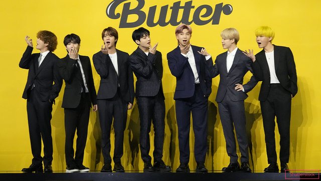 BTS-making-fun-faces-wearing-suits-in-front-of-Butter-sign_tcm25-661552.jpg