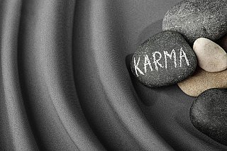 stones-with-word-karma-grey-fabric-view-space-text-small.jpg