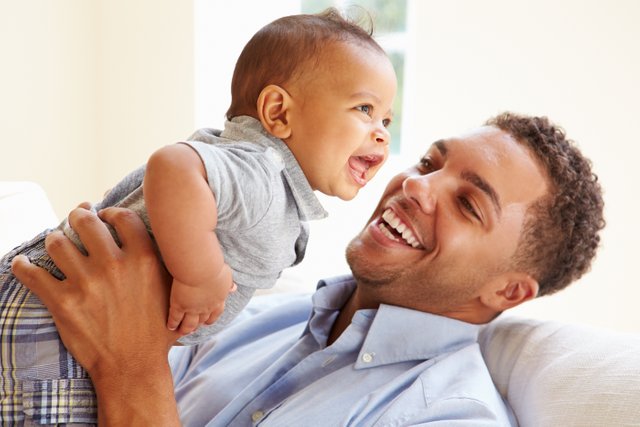 bigstock-Smiling-Father-Playing-With-Ba-73038859.jpg