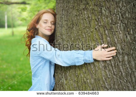 stock-photo-contented-young-woman-hugging-a-large-tree-with-a-blissful-expression-and-her-eyes-closed-in-a-639484663.jpg