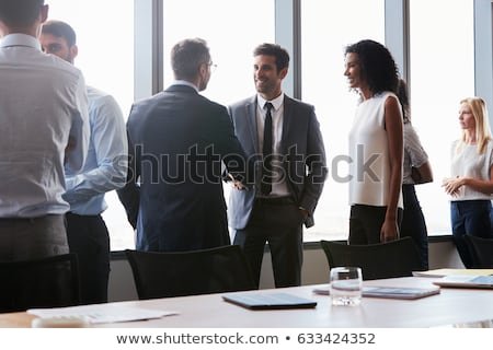 businesspeople-shaking-hands-before-meeting-450w-633424352.jpg