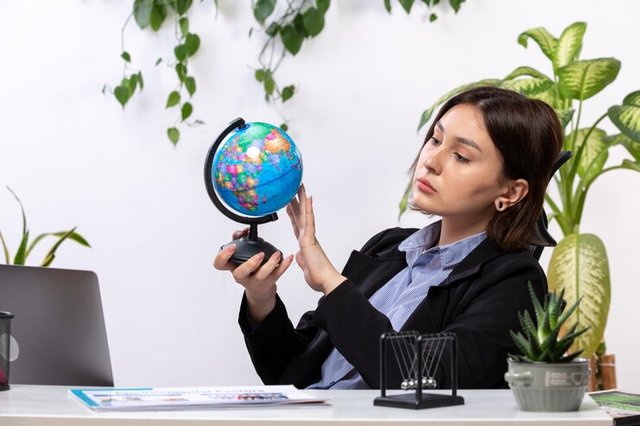 front-view-beautiful-young-businesswoman-black-jacket-blue-shirt-observing-little-globe-front-table-business-job-office_140725-15842.jpg