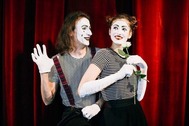 portrait-two-happy-mime-artist-front-red-curtain_23-2147891688.jpg